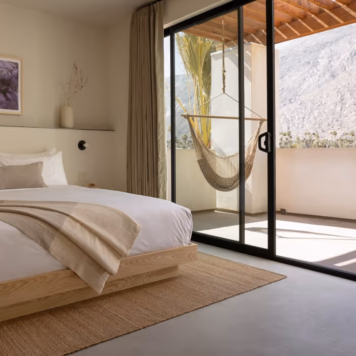 Habitación de Drift Palm Springs con cama de madera y balcón